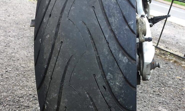 a badly worn back tyre on an Aprilia Dorsoduro