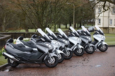 Suzuki Burgman 650 Executive's line-up for duty. Spot the odd one out.