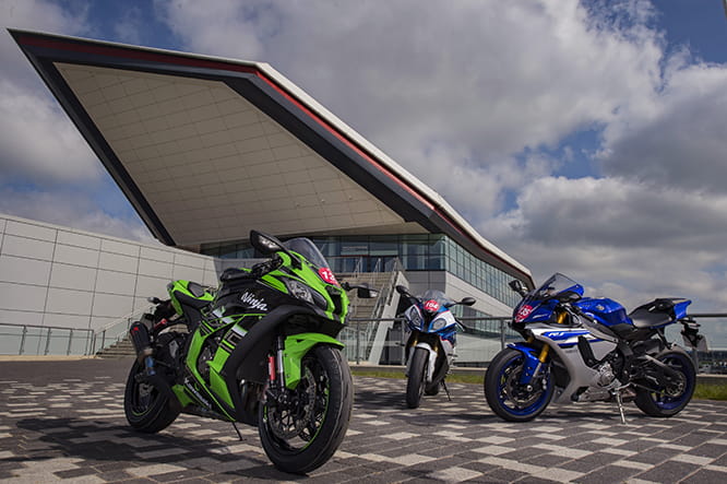 In front of the iconic Wing at Silverstone the trio await their track time