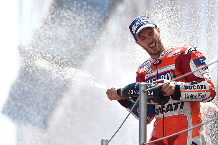 Andrea Dovisozo sprays champagne on the winners podium