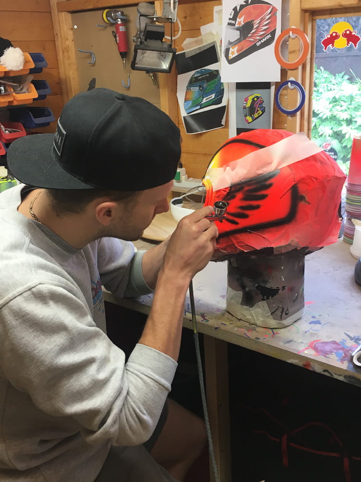 DrKolor uses an airbrush to paint a helmet