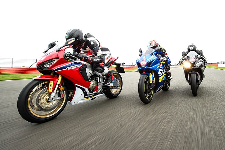 Three Superbikes ride on track in formation