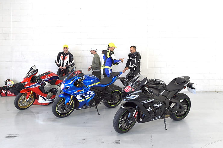 Honda, Suzuki and Kawasaki in a pit garage