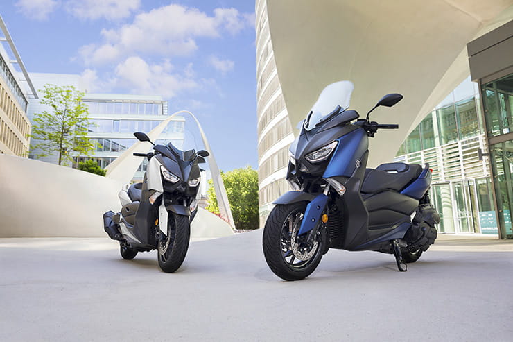 Two 2017 Yamaha X Max 400s outside a building