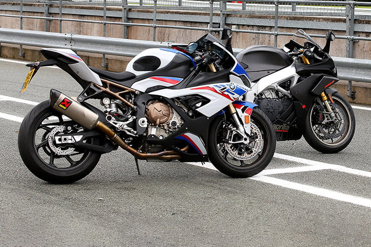 We take two of 2019’s finest production sport bikes, the RSV4 & S1000RR, with 420bhp between them and head to Oulton Park with guest tester John McGuinness.
