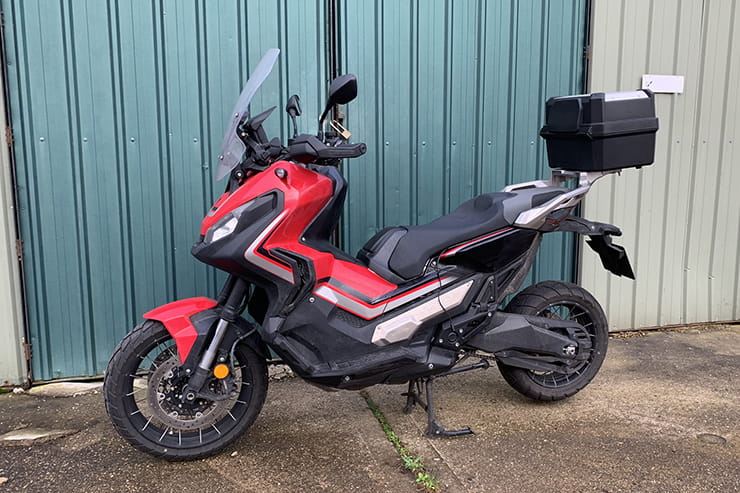 Honda’s 750cc, 75mpg adventure commuter scooter continues to defy convention. But we love it all the same