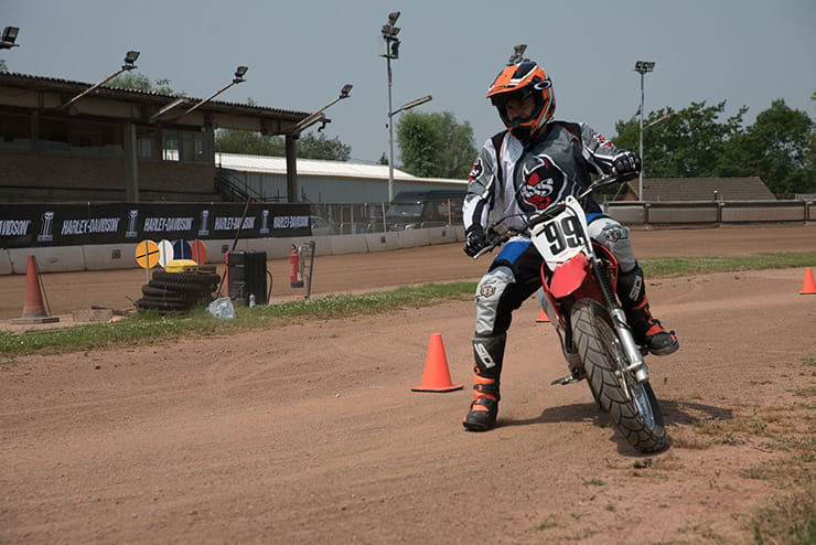 Kane practicing manoeuvres on a flat track bike