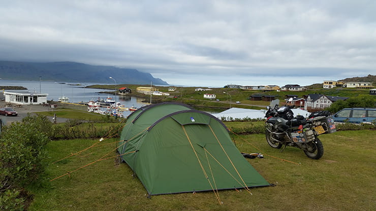 motorbike next to a tent at a campsite on a motorcycle touring trip