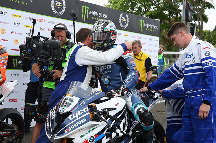 Michael Dunlop is congratulated by his Tyco BMW team