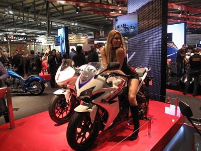 Honda's CBR500R, and a pretty girl. Race bike is in the background