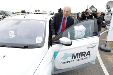 Vince Cable in the passenger seat while a non-driving driver doesn't take the wheel