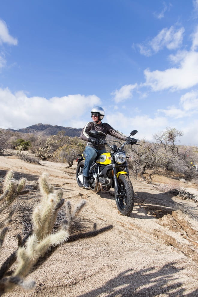 Ducati's Scrambler strikes a pose off-road. Roland does too.