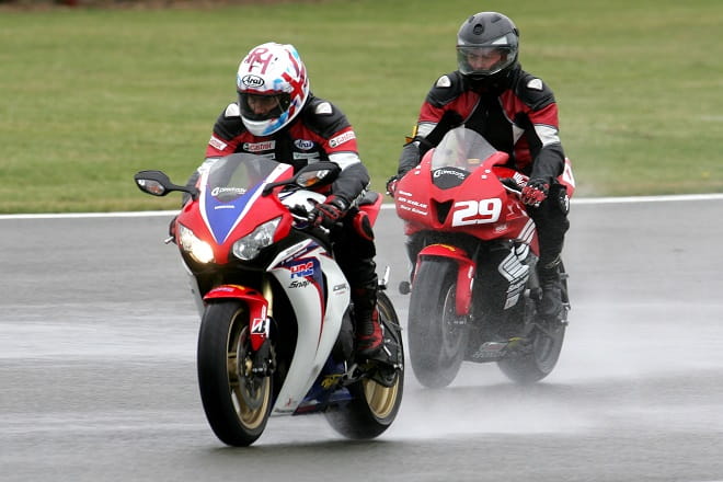 Ron Haslam leads the way on a Fireblade SP at a wet Donington Park